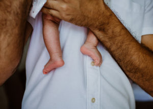 baby feet dad holding baby